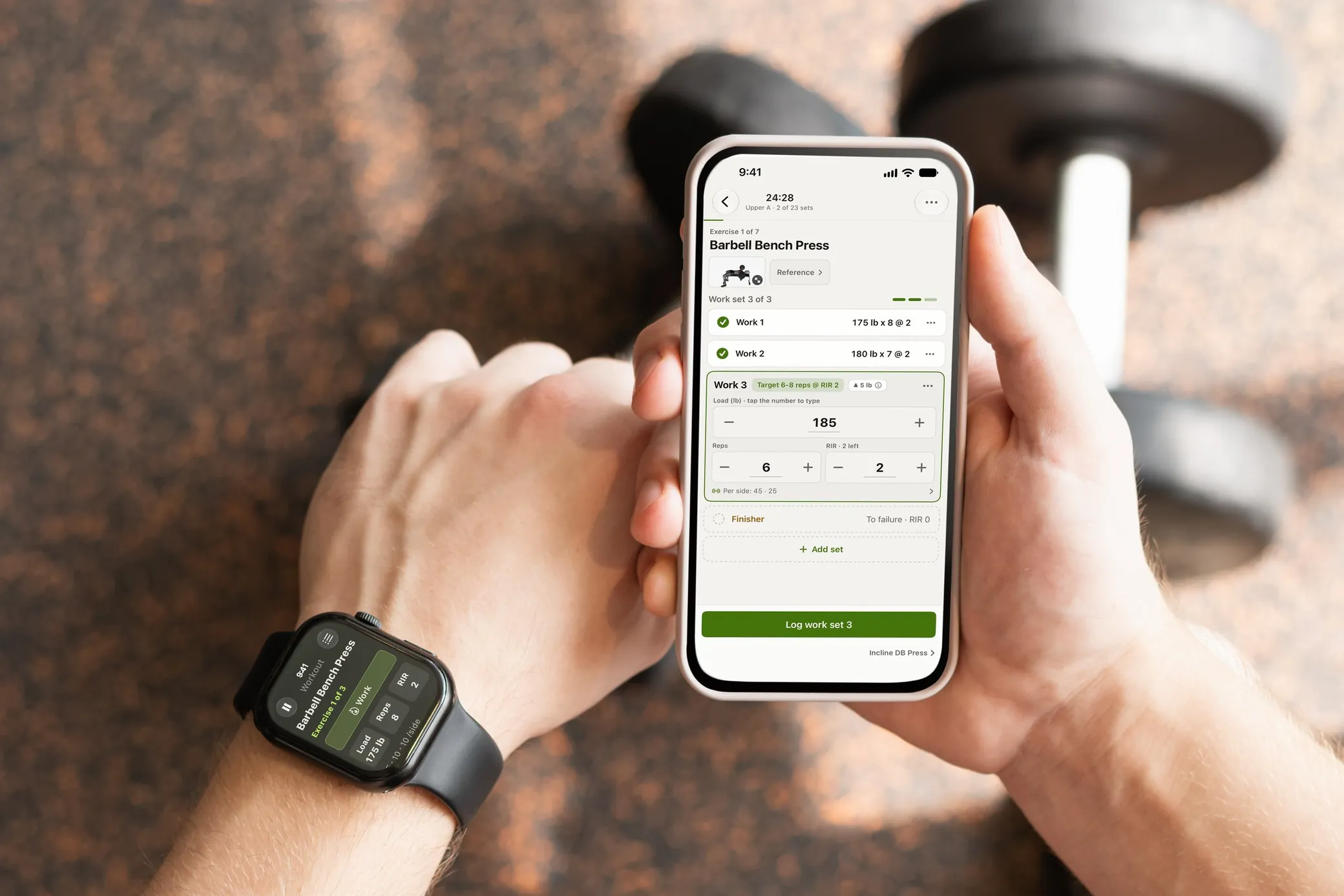 A lifter checks RIRLift on an Apple Watch, the same barbell bench press session open on the wrist and on the iPhone in the other hand and a dumbbell on the gym floor behind